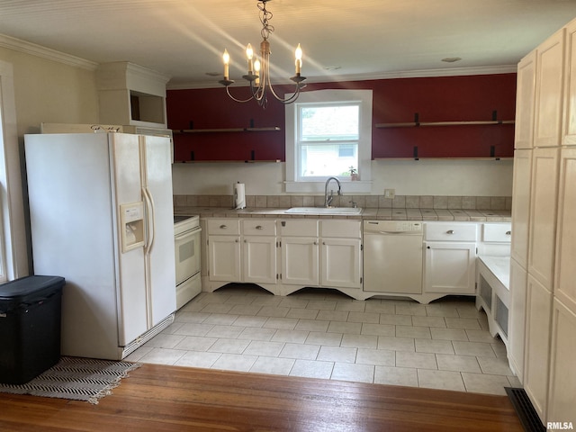 706 N Main St, Port Byron, IL 61275 - kitchen featuring white appliances, tile countertops, ornamental molding, a chandelier, and white cabinets