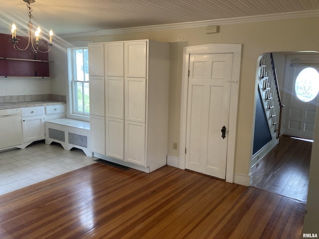 706 N Main St, Port Byron, IL 61275 - unfurnished dining area featuring ornamental molding, wood-type flooring, stairs, and a chandelier