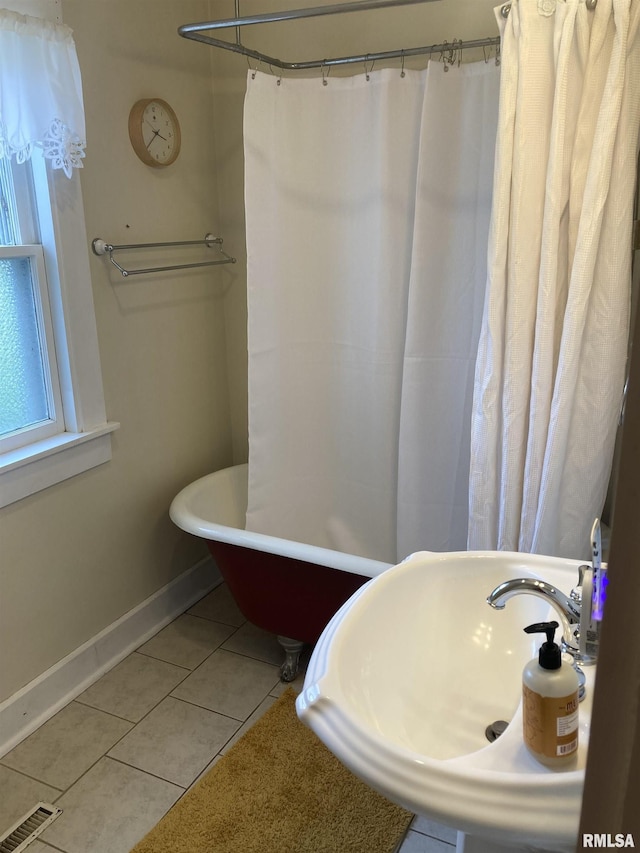 706 N Main St, Port Byron, IL 61275 - bathroom with a freestanding bath, tile patterned floors, and a shower with curtain
