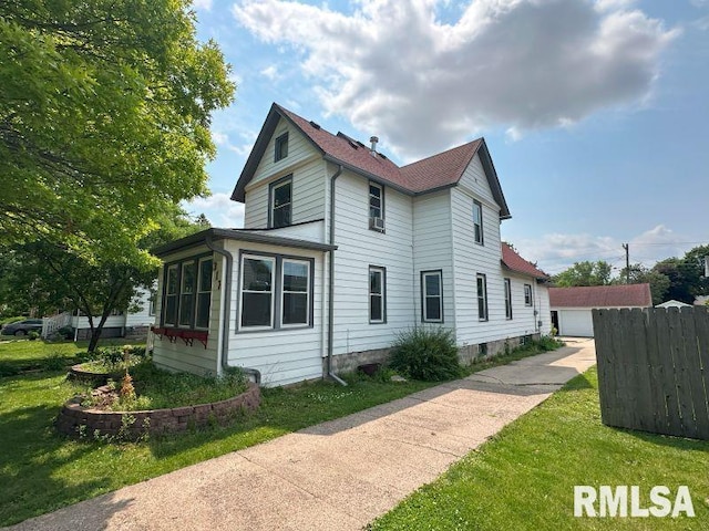 317 9th St, De Witt, IA 52742 - view of side of property featuring a detached garage and an outbuilding