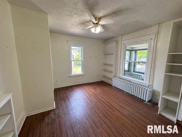 317 9th St, De Witt, IA 52742 - spare room with radiator heating unit, healthy amount of natural light, ceiling fan, a textured ceiling, and baseboards