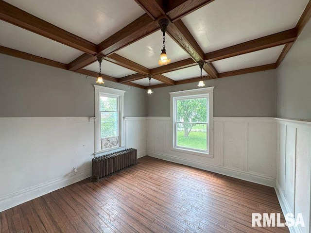 317 9th St, De Witt, IA 52742 - unfurnished room with radiator, healthy amount of natural light, wainscoting, coffered ceiling, and beamed ceiling