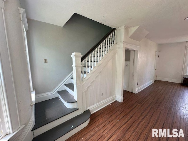 317 9th St, De Witt, IA 52742 - staircase with wood finished floors and baseboards