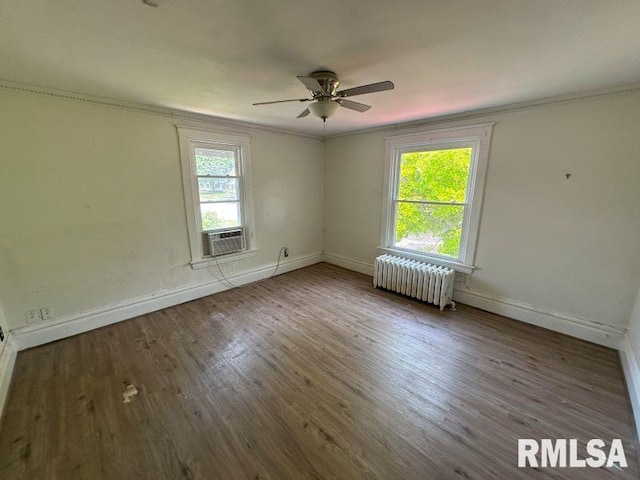 317 9th St, De Witt, IA 52742 - empty room with radiator heating unit, baseboards, a ceiling fan, cooling unit, and crown molding