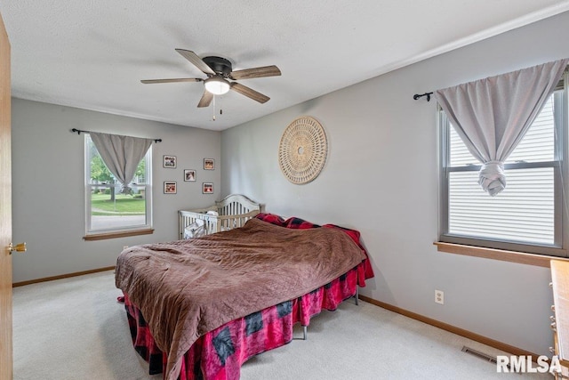 3115 W 63rd St, Davenport, IA 52806 - carpeted bedroom with baseboards and a ceiling fan