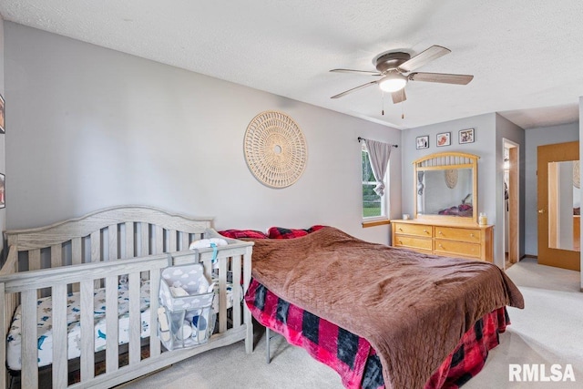 3115 W 63rd St, Davenport, IA 52806 - carpeted bedroom featuring a textured ceiling and a ceiling fan