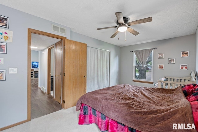 3115 W 63rd St, Davenport, IA 52806 - bedroom featuring a textured ceiling, ceiling fan, and wood finished floors