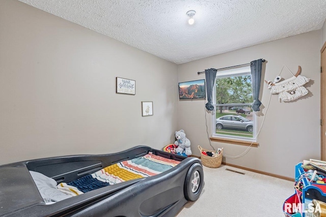 3115 W 63rd St, Davenport, IA 52806 - bedroom featuring carpet flooring, a textured ceiling, and baseboards