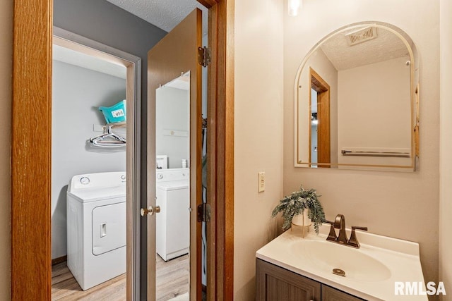 3115 W 63rd St, Davenport, IA 52806 - bathroom featuring vanity, a textured ceiling, and wood finished floors