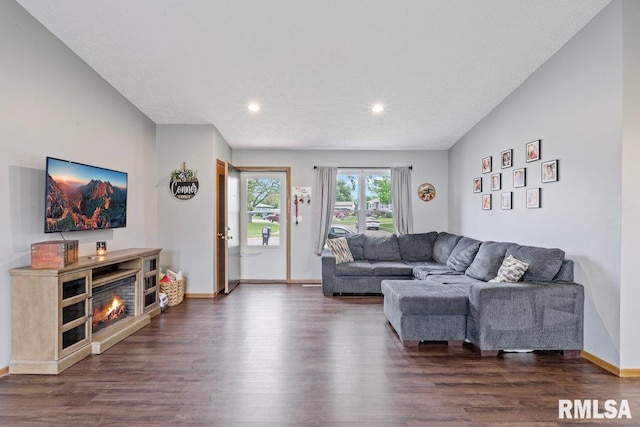 3115 W 63rd St, Davenport, IA 52806 - living room featuring dark wood-type flooring, recessed lighting, baseboards, and a glass covered fireplace