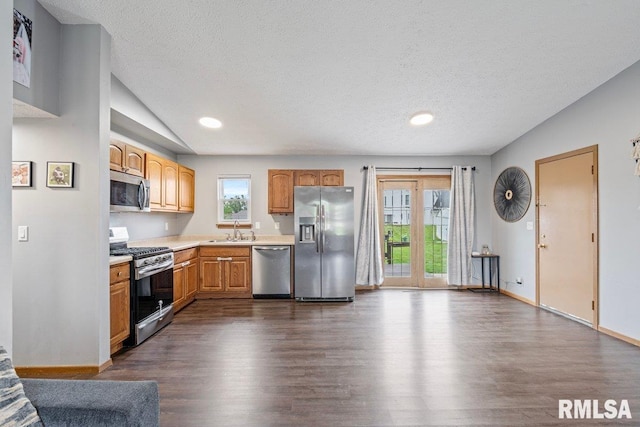 3115 W 63rd St, Davenport, IA 52806 - kitchen with appliances with stainless steel finishes, a sink, dark wood-type flooring, light countertops, and a textured ceiling