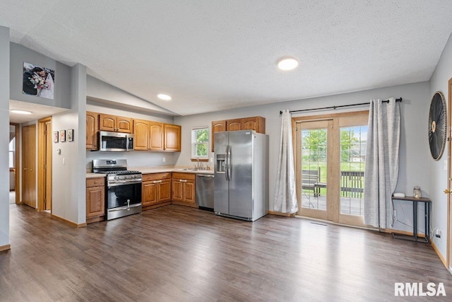 3115 W 63rd St, Davenport, IA 52806 - kitchen with stainless steel appliances, a sink, vaulted ceiling, dark wood finished floors, and light countertops