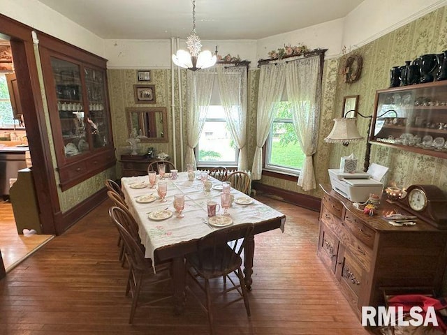 605 Fulton St, Grand Mound, IA 52751 - dining area with a chandelier, hardwood / wood-style floors, healthy amount of natural light, and wallpapered walls