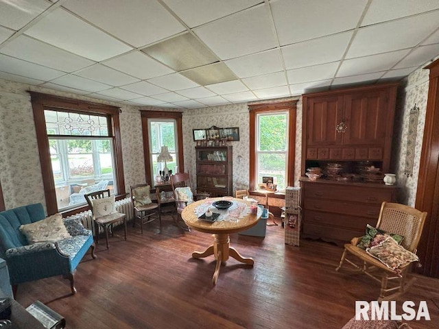 605 Fulton St, Grand Mound, IA 52751 - living area featuring wallpapered walls, dark wood finished floors, and a drop ceiling