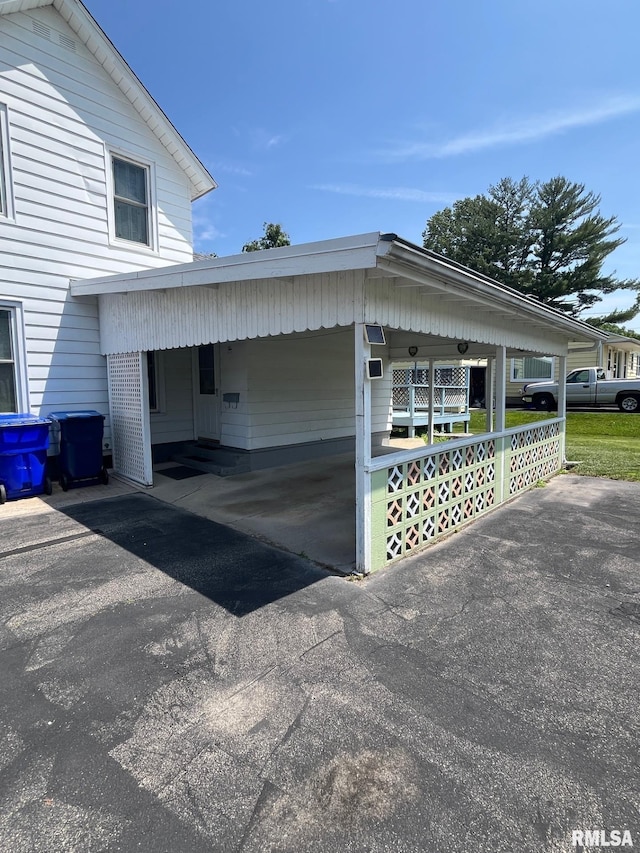246 Willard St, Kewanee, IL 61443 - view of home's exterior featuring a carport and asphalt driveway