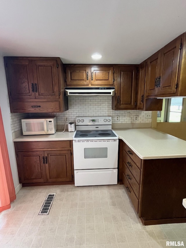 246 Willard St, Kewanee, IL 61443 - kitchen featuring white appliances, extractor fan, light countertops, and decorative backsplash