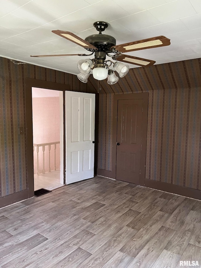 246 Willard St, Kewanee, IL 61443 - bonus room with wood finished floors, ceiling fan, and wallpapered walls