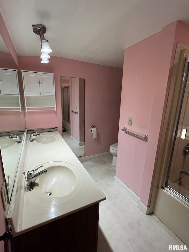 246 Willard St, Kewanee, IL 61443 - bathroom with baseboards, double vanity, toilet, enclosed tub / shower combo, and tile patterned floors