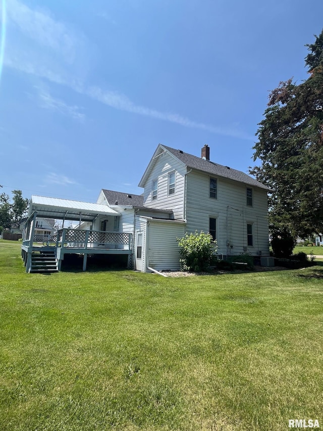 246 Willard St, Kewanee, IL 61443 - rear view of house with a wooden deck, a chimney, and a lawn