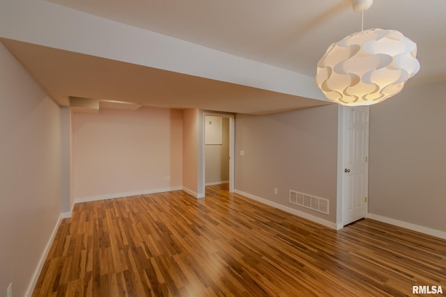 3461 Cedarview Ct, Bettendorf, IA 52722 - finished below grade area with wood finished floors, baseboards, and a chandelier
