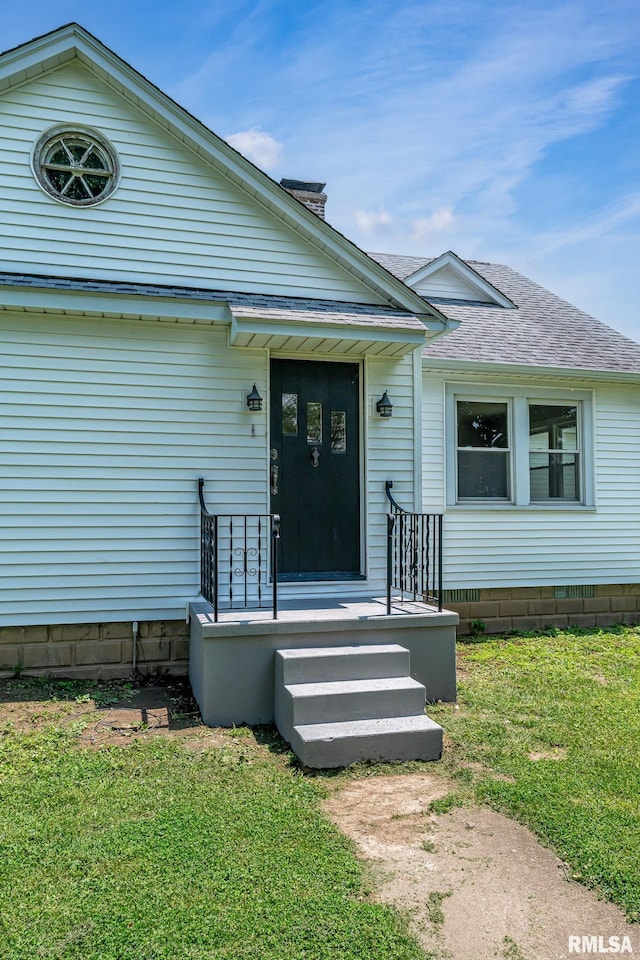4418 11th St, East Moline, IL 61244 - doorway to property with a yard and a shingled roof
