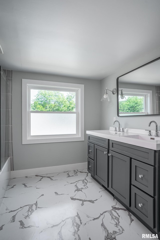 4418 11th St, East Moline, IL 61244 - full bath with double vanity, baseboards, and marble finish floors