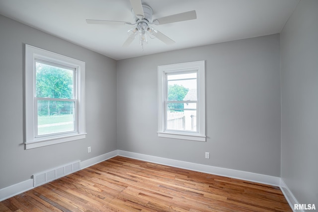 4418 11th St, East Moline, IL 61244 - empty room with plenty of natural light, light wood-style flooring, baseboards, and a ceiling fan