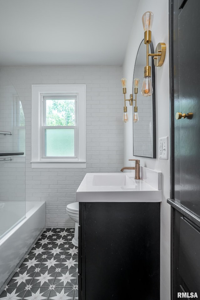4418 11th St, East Moline, IL 61244 - bathroom featuring toilet, vanity, tile patterned floors, and tub / shower combination