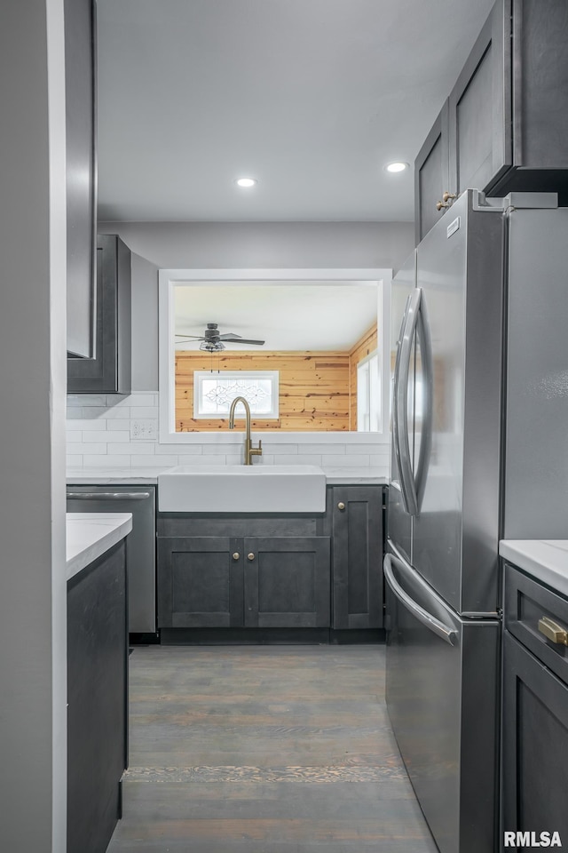 4418 11th St, East Moline, IL 61244 - kitchen with appliances with stainless steel finishes, a sink, light countertops, wood finished floors, and recessed lighting