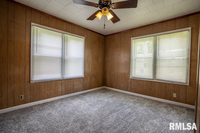 710 S Bentley St, Marion, IL 62959 - empty room featuring a ceiling fan, carpet floors, wood walls, and baseboards