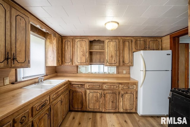 710 S Bentley St, Marion, IL 62959 - kitchen featuring freestanding refrigerator, a sink, and brown cabinets