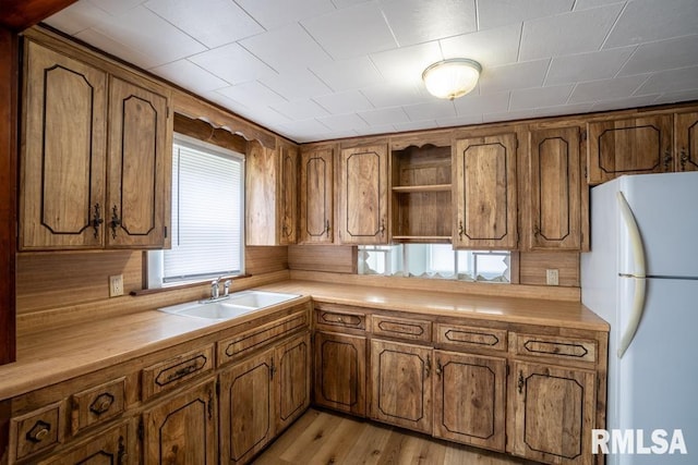 710 S Bentley St, Marion, IL 62959 - kitchen with freestanding refrigerator, a sink, and brown cabinets