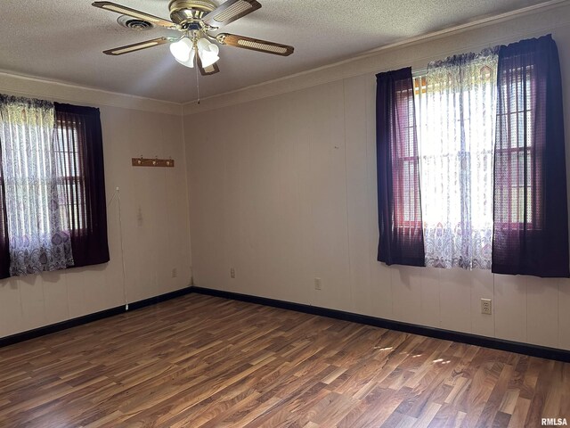 690 Railroad St, Tamms, IL 62988 - empty room with wood finished floors, a ceiling fan, a textured ceiling, ornamental molding, and baseboards