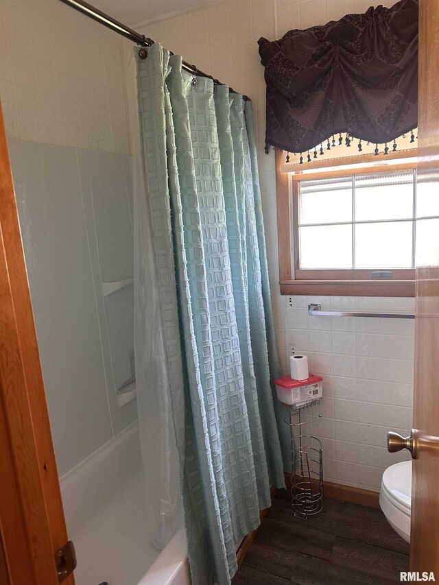690 Railroad St, Tamms, IL 62988 - full bath featuring wood finished floors, toilet, shower / tub combo, and tile walls