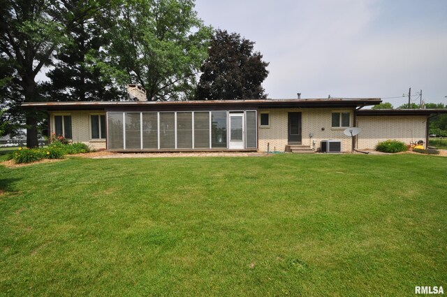 18616 N 35th Ave, East Moline, IL 61244 - back of house featuring entry steps, a yard, a chimney, and brick siding