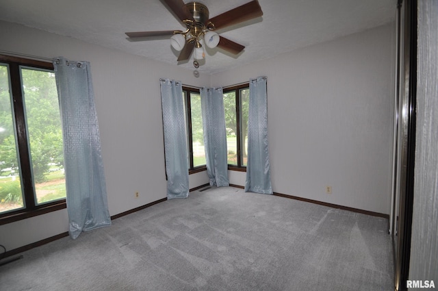 18616 N 35th Ave, East Moline, IL 61244 - unfurnished room featuring plenty of natural light, a ceiling fan, and carpet flooring