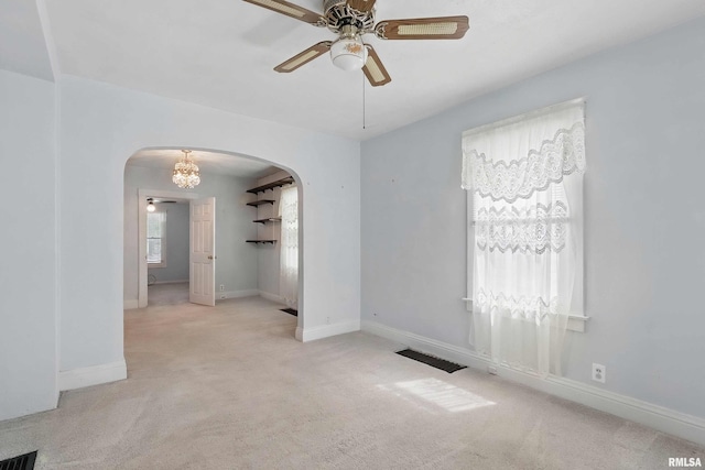 2947 12th Ave, Moline, IL 61265 - empty room with arched walkways, a ceiling fan, carpet, and baseboards