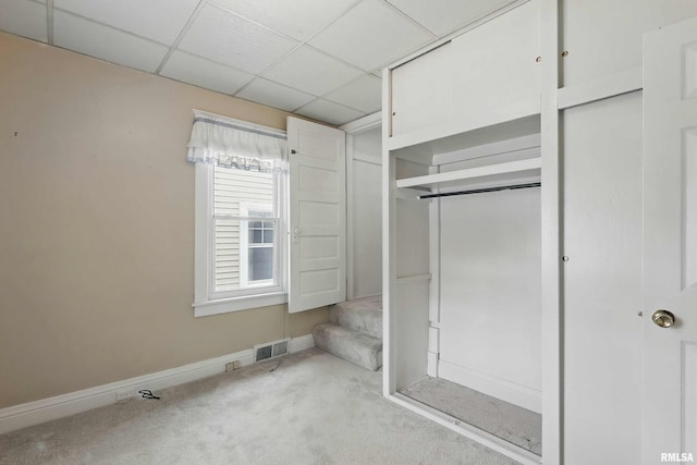 2947 12th Ave, Moline, IL 61265 - unfurnished bedroom with carpet flooring, baseboards, a closet, and a drop ceiling