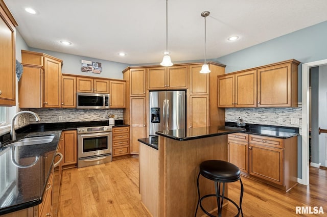308 N 9th Ave N, Fulton, IL 61252 - kitchen featuring appliances with stainless steel finishes, a sink, light wood-type flooring, backsplash, and recessed lighting