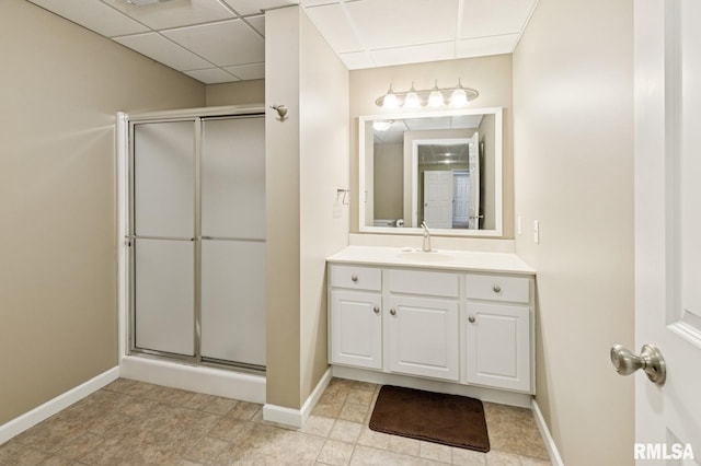 308 N 9th Ave N, Fulton, IL 61252 - bathroom featuring a shower stall, vanity, a drop ceiling, and baseboards