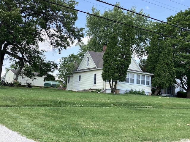 136 W Mill St, Kewanee, IL 61443 - view of side of property with a chimney, a lawn, and roof with shingles