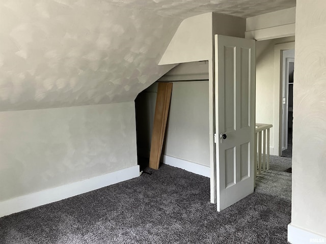 136 W Mill St, Kewanee, IL 61443 - bonus room with dark colored carpet, lofted ceiling, and baseboards