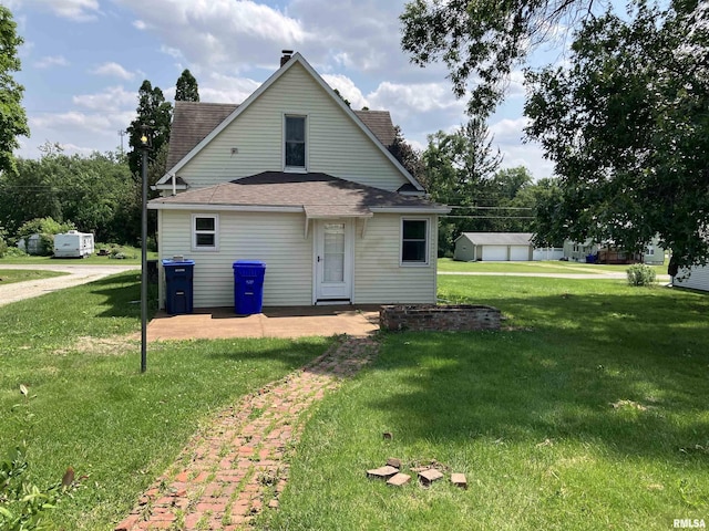 136 W Mill St, Kewanee, IL 61443 - rear view of house with roof with shingles and a lawn