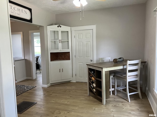 136 W Mill St, Kewanee, IL 61443 - dining room with ceiling fan, light wood-style floors, a textured ceiling, and baseboards