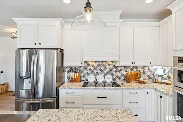 18101 271st St, Long Grove, IA 52756 - kitchen with appliances with stainless steel finishes, white cabinets, decorative backsplash, and recessed lighting