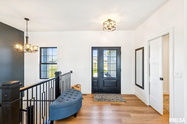 18101 271st St, Long Grove, IA 52756 - foyer entrance featuring a chandelier, light wood finished floors, plenty of natural light, and baseboards