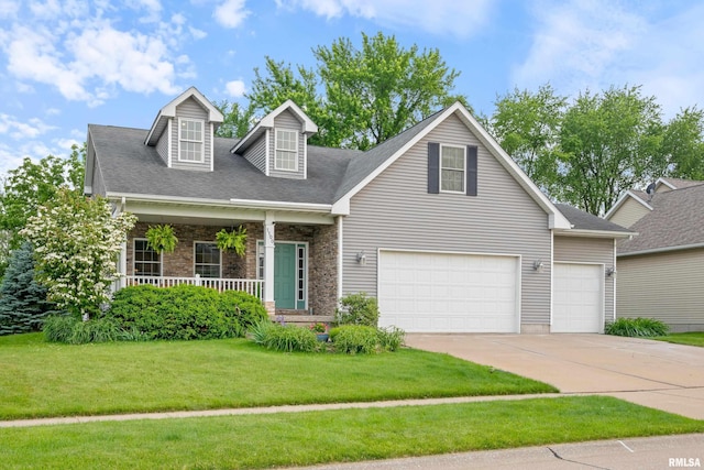 1100 Wild W Dr, Le Claire, IA 52753 - view of front of house with driveway, a front lawn, a porch, and a garage