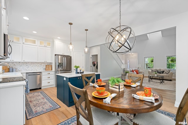1100 Wild W Dr, Le Claire, IA 52753 - dining area with light wood-style flooring, a chandelier, and recessed lighting