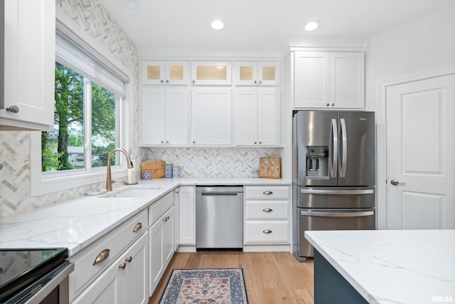 1100 Wild W Dr, Le Claire, IA 52753 - kitchen with appliances with stainless steel finishes, white cabinetry, light wood-style floors, light stone counters, and recessed lighting
