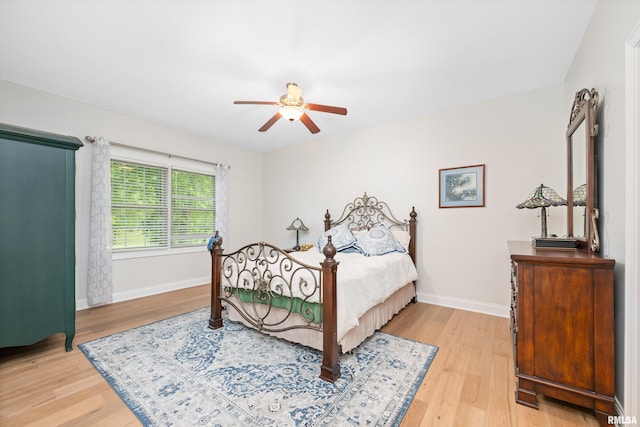 1100 Wild W Dr, Le Claire, IA 52753 - bedroom with light wood-style flooring and a ceiling fan